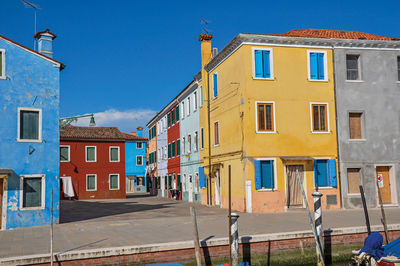 Colorful buildings in front of a canal at burano, a gracious little town full of canals in italy.