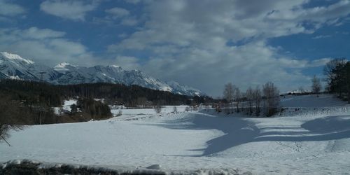 Scenic view of snowcapped mountains against sky