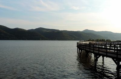 Pier over lake against sky