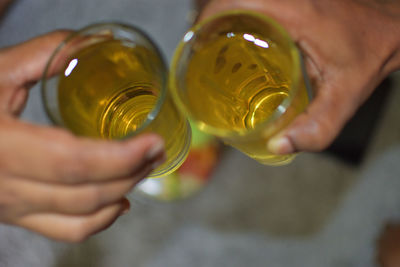 Midsection of man holding beer glass