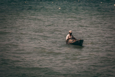 People in boat at sea