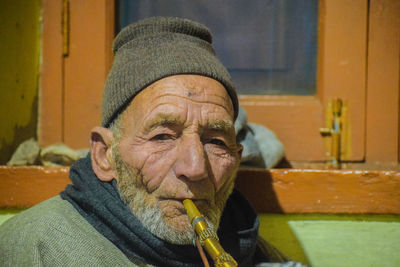 Portrait of senior man smoking hookah