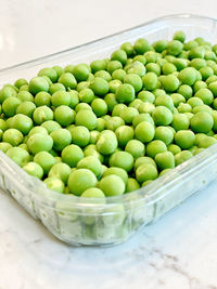 High angle view of green fruits in container