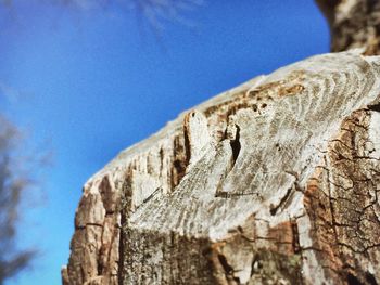 Low angle view of rocks against blue sky