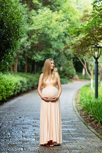 Rear view of woman standing on footpath