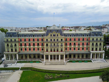 View of buildings in city against cloudy sky
