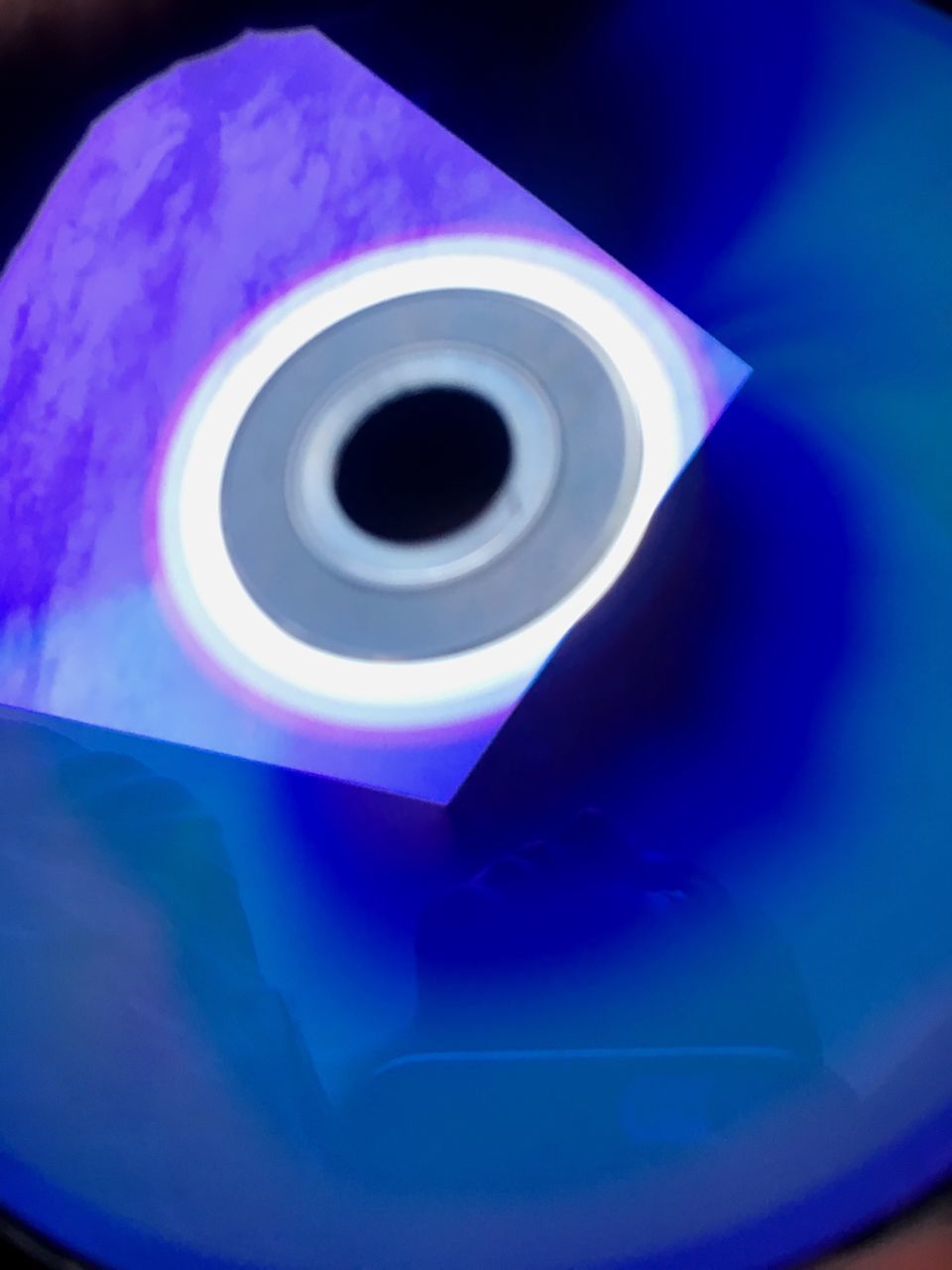 CLOSE-UP OF PAPER AND BLUE CAMERA