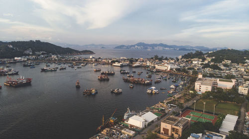 High angle view of townscape by sea against sky