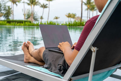 Low section of woman using laptop