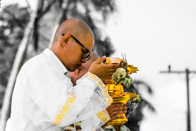 Side view of buddhist monks worshipping