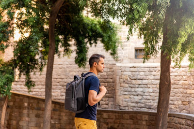 Full length of man standing by tree in city