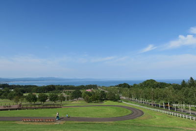 Scenic view of golf course against sky