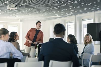 Group of business people attending presentation during conference