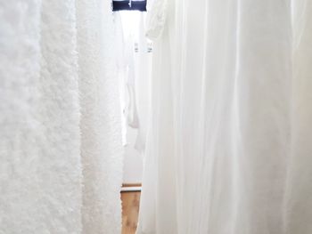 White clothes hanging in store