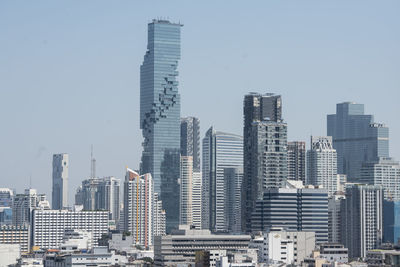Modern buildings in city against clear sky