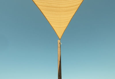 Low angle view of cross against clear blue sky