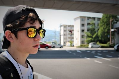 Boy wearing sunglasses in city