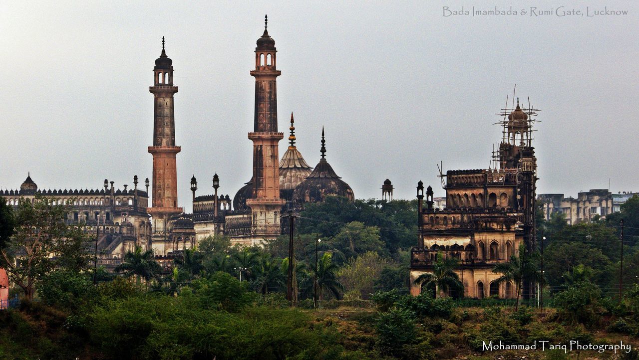 architecture, built structure, building exterior, tower, lighthouse, religion, guidance, famous place, tree, clear sky, place of worship, travel destinations, history, church, spirituality, tourism, travel, sky