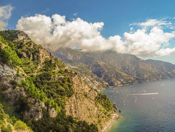 Scenic view of sea and mountains against sky