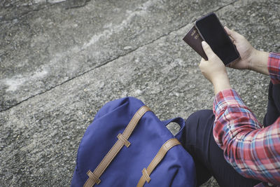 Midsection of man using mobile phone