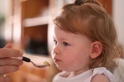 Close-up portrait of cute girl eating