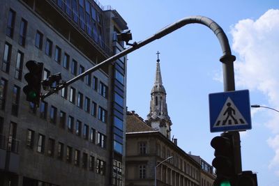 Low angle view of road sign against buildings