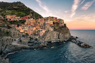 Scenic view of sea by buildings against sky