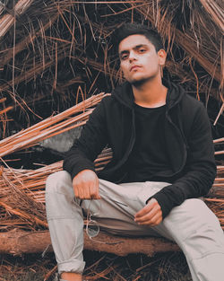 Portrait of young man sitting outdoors