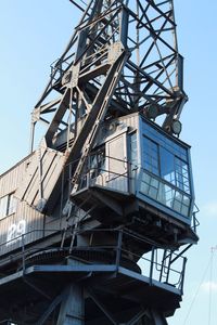 Low angle view of crane against sky