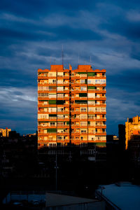 Buildings against sky at sunset