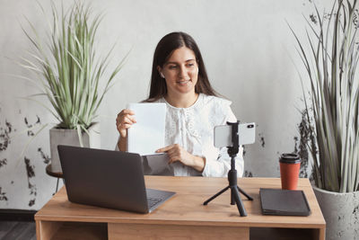 Freelancer woman talking on video call at home