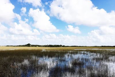 Scenic view of lake against cloudy sky