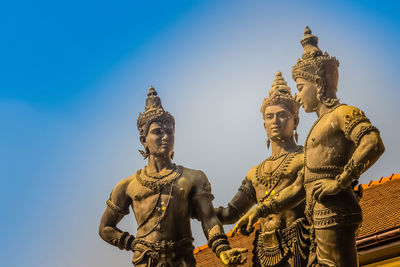 Low angle view of statue against sky