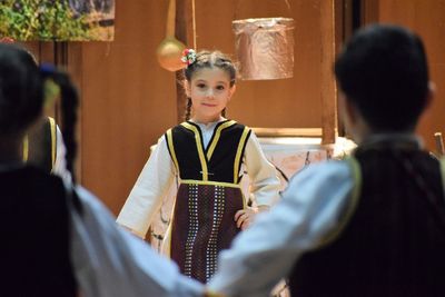 Portrait of girl with friends wearing traditional clothing at event