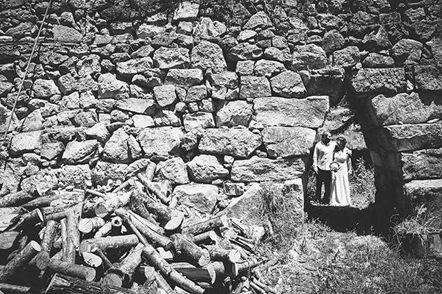 firewood, abandoned, stack, field, lumber industry, old, abundance, obsolete, damaged, log, stone wall, large group of objects, run-down, deforestation, deterioration, stone - object, day, wood - material, outdoors, high angle view