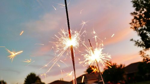 Low angle view of firework display at night