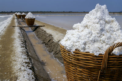 Salt in the bamboo basket on the ground near salt pan, thailand