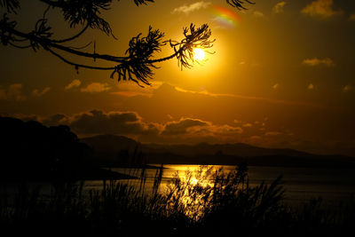 Scenic view of lake against orange sky