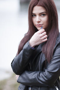 Portrait of young woman wearing leather jacket