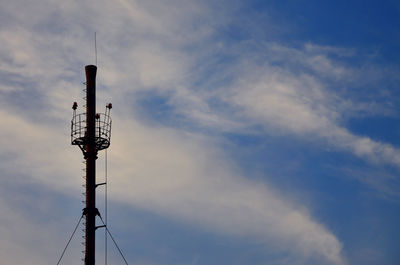 Low angle view of communications tower against sky