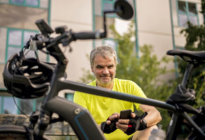 Mature man taking a break during his bike tour with an e-bike