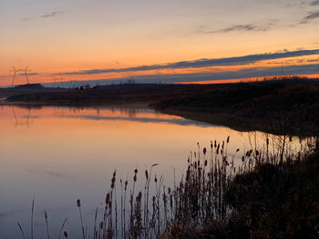 Scenic view of lake against sky during sunset