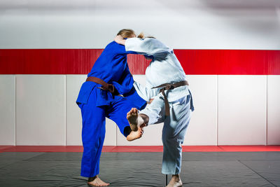 Rear view of man standing against wall