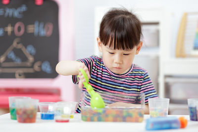 Young girl play science experiments for homeschooling