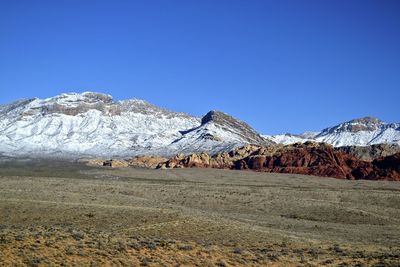 Scenic view of mountains against clear blue sky