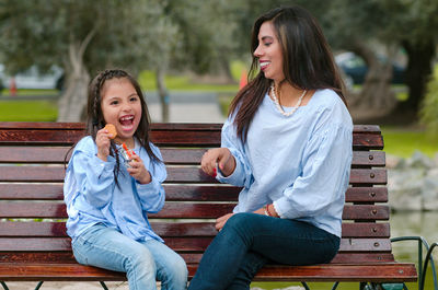 Woman sitting on bench in park