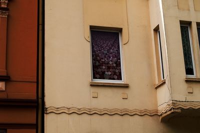 Low angle view of window on wall of building