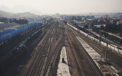 High angle view of railroad tracks in city against sky