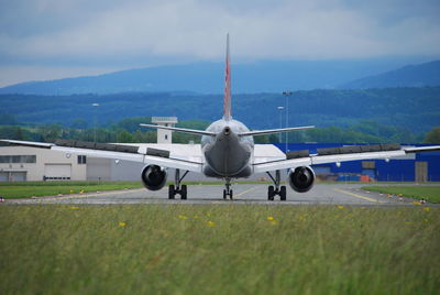 Airplane on runway against sky