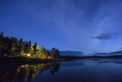 Scenic view of lake against sky at night